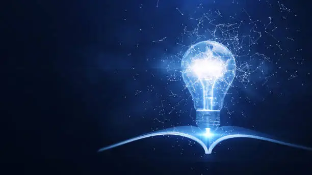 Photo of Learning from books or textbooks and the Internet brings new ideas. polygons connected around A glowing light bulb with a book on the bottom stands out on the right. dark blue background. 3D rendering