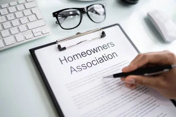 Person Reading HOA Rules And Regulations Document