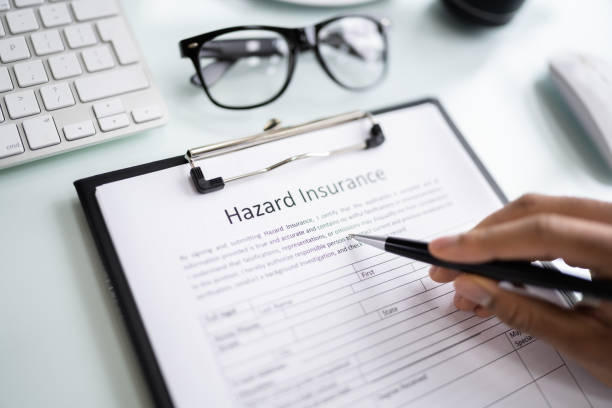 istock Man Filling Hazard Insurance Form 1364971546