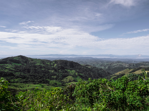 A view on hills in Puntarenas Province of Costa Rica with Gulf of Nicoya in the distance.