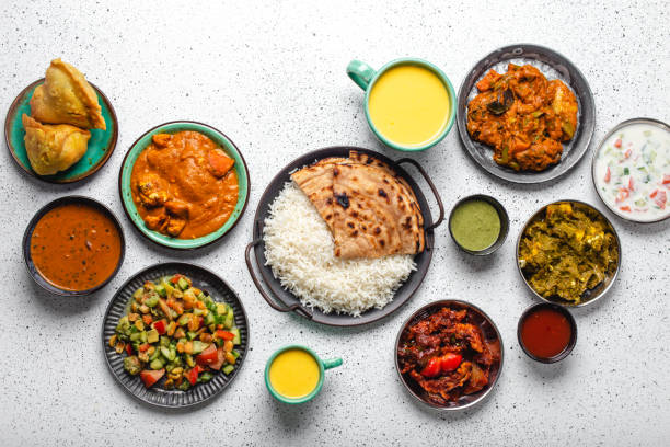 istock Indian ethnic food buffet on white concrete table from above 1364975911