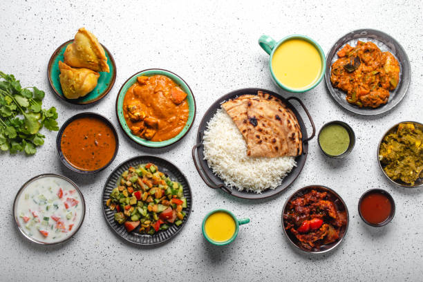 istock Indian ethnic food buffet on white concrete table from above 1364975925