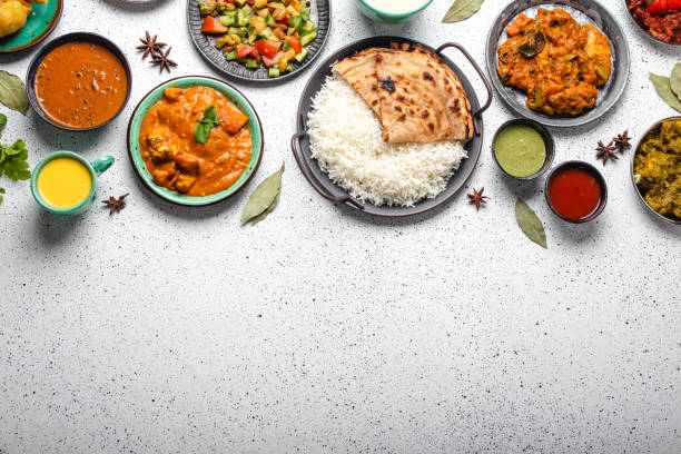 istock Indian ethnic food buffet on white concrete table top view copy space 1364975933