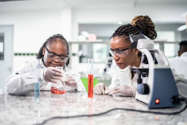 istock Teacher teaching a student with special needs in the laboratory 1364980213