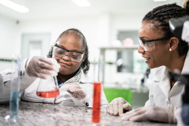 istock Teacher teaching a student with special needs in the laboratory 1364980223