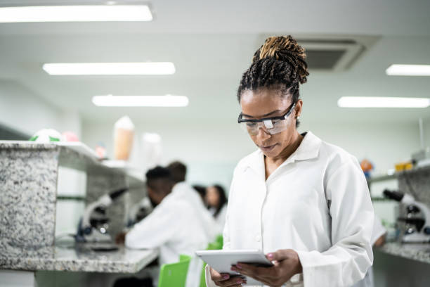 istock Mature woman using a digital tablet in the laboratory 1364980247