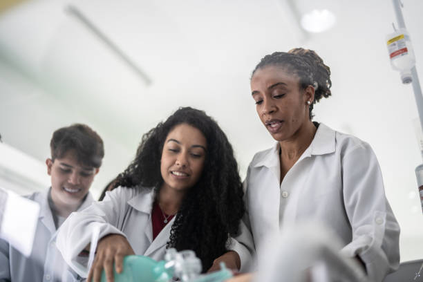 un enseignant explique comment effectuer une procédure médicale en classe - teacher professor science university photos et images de collection