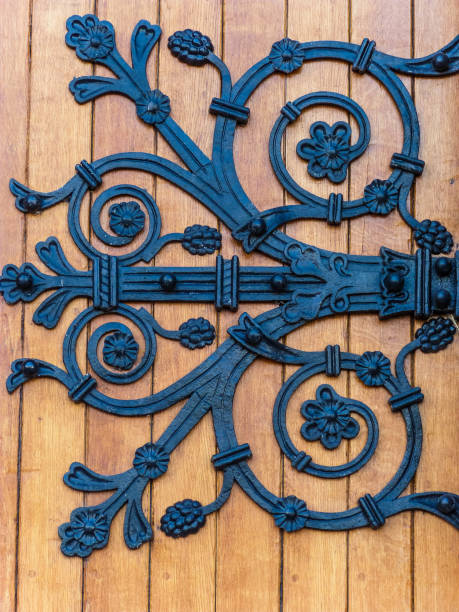 istock amazing black ironwork on wooden front door 1364982500