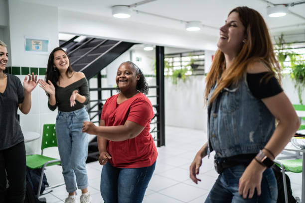 istock Group of friends dancing at school's patio 1364983959