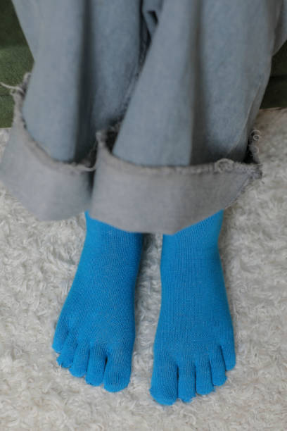 istock Feet in modern finger socks. 1364984298