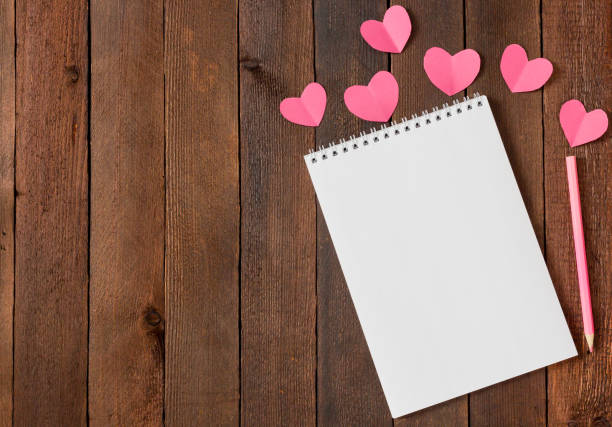istock hearts on wooden background with copy space 1364984311