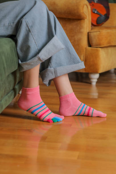 istock Feet in modern finger socks. 1364984323