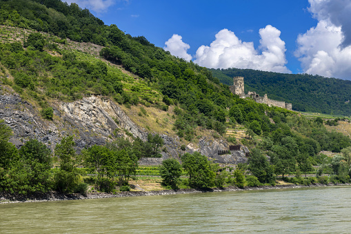 Spitz, Austria, July 3, 2021: View of the left bank of the Danube River in Danube Valley (Wachau) with the ruined Hinterhaus castle. Wachau is listed as UNESCO World Heritage Site.