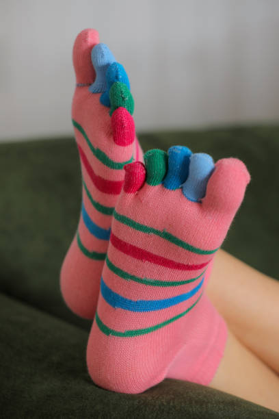 istock Feet in modern finger socks. 1364984871