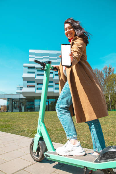 istock renting electric kick scooter using phone 1364985666