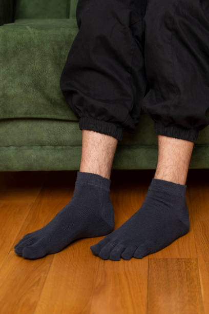 istock Feet in modern finger socks. 1364985823