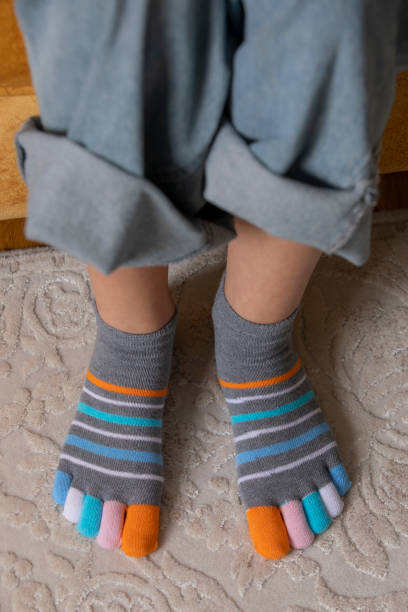 istock Feet in modern finger socks. 1364985897