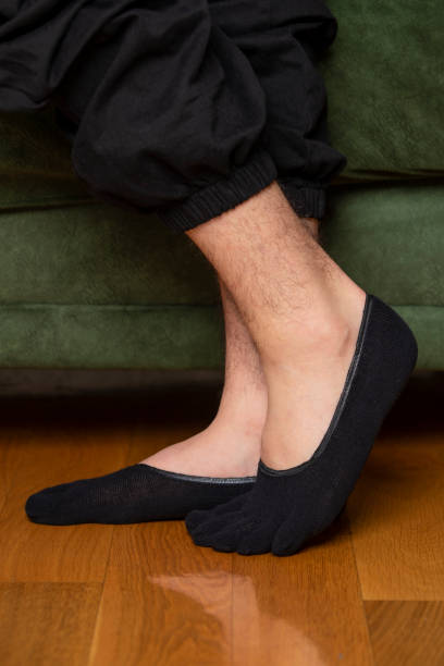 istock Feet in modern finger socks. 1364985962
