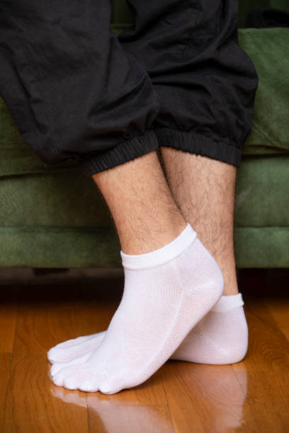 istock Feet in modern finger socks. 1364986073