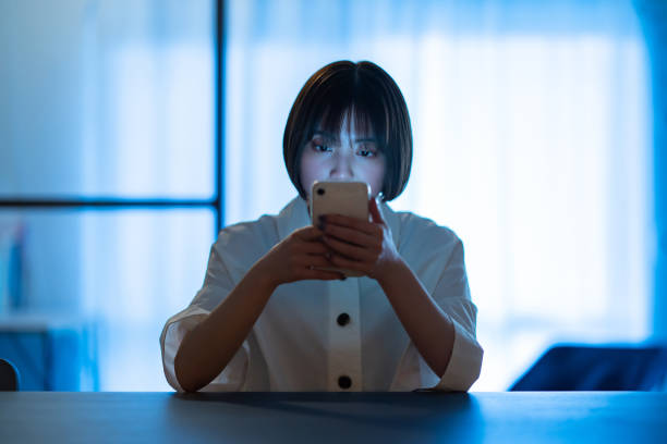 istock A woman staring at a smartphone with a stern look 1364987833