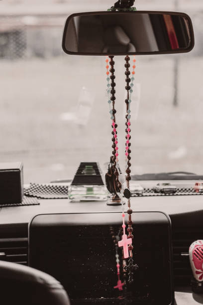 istock Rosary beads hanging in the mirror in the car 1364987839