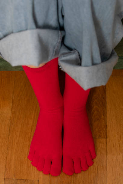 istock Feet in modern finger socks. 1364988822