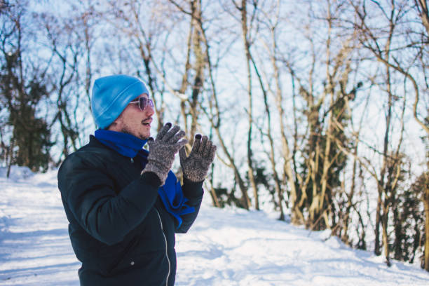 istock a young man with winter gloves 1364991259