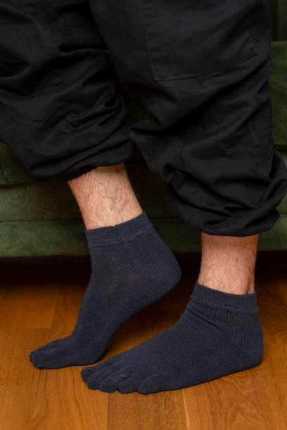 istock Feet in modern finger socks. 1364991392