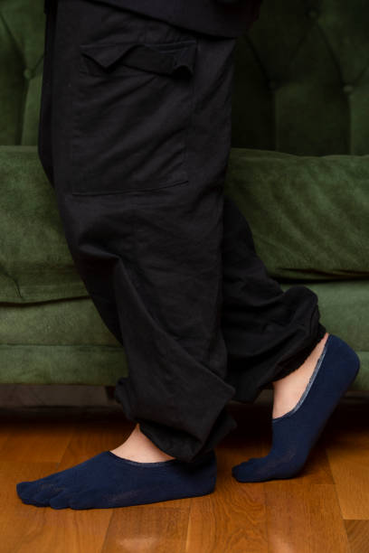 istock Feet in modern finger socks. 1364991423