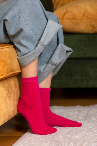 istock Feet in modern finger socks. 1364991519