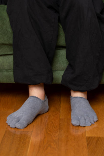 istock Feet in modern finger socks. 1364991860
