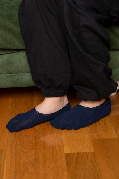 istock Feet in modern finger socks. 1364991886