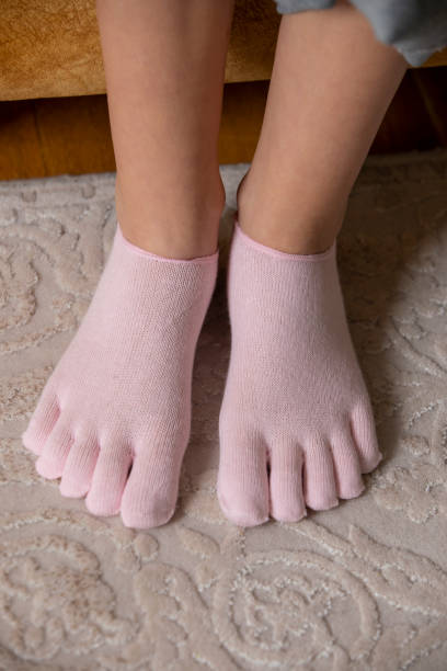 istock Feet in modern finger socks. 1364992680