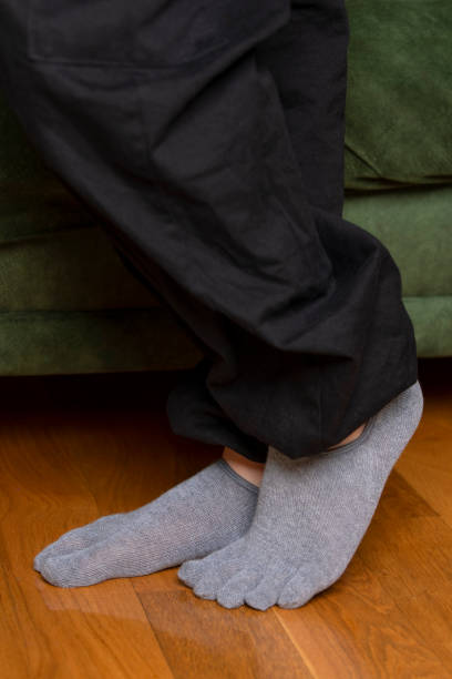 istock Feet in modern finger socks. 1364992799