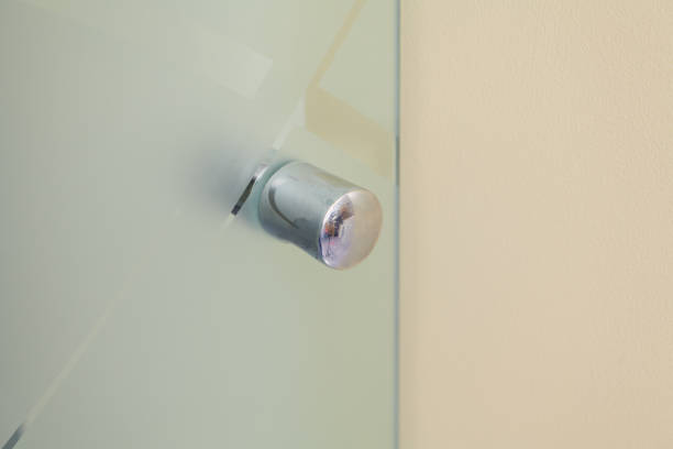 istock Metal handle on glass door close up 1364994827