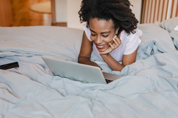 istock African American woman using laptop in bed 1364996273
