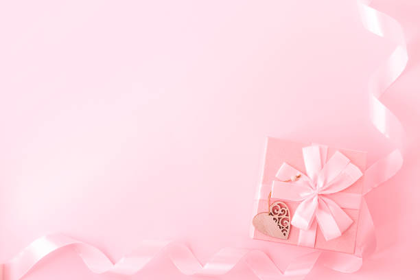 istock Gift or present box and ribbon on pastel pink background top view. Flat lay. Valentine's day, Birthday, wedding or christmas concept. Copy space. 1364996909