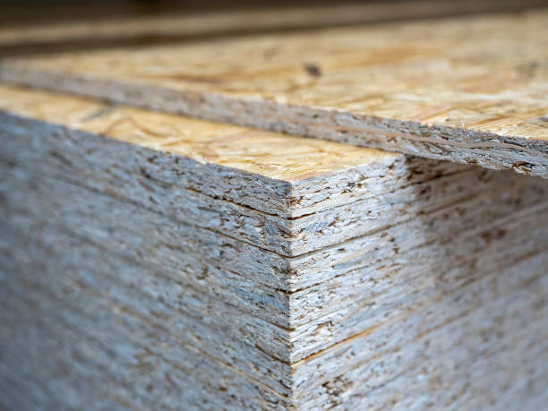 istock Close-up of a stack of OSB sheets. Lumber, construction, selective focus 1364997179