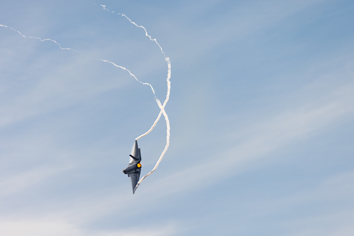 F-35C Lightning II  in a high G maneuver, with trails at the wing tips and afterburner on