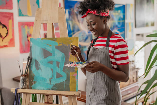 istock A young female artist expresses her creativity through painting 1365002031