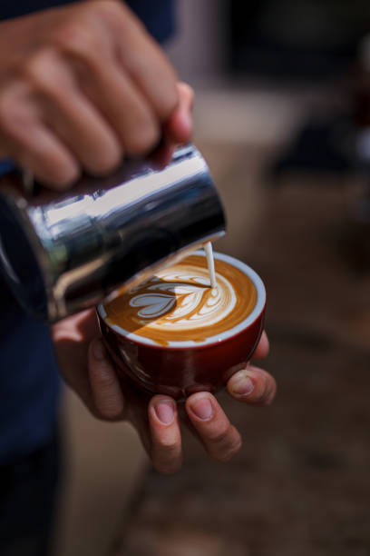 istock Barista performing skill of pouring latte art 1365002036