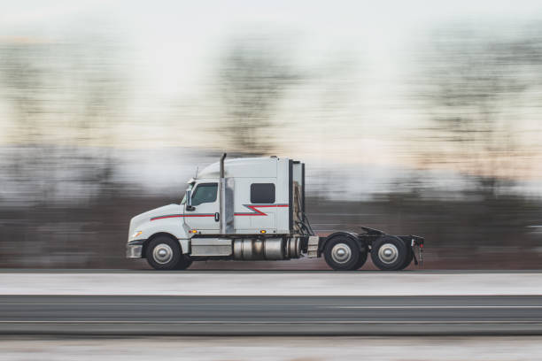 Semi truck on a multi lane highway in Winter. Slow shutter panning shot with lots of motion blur.