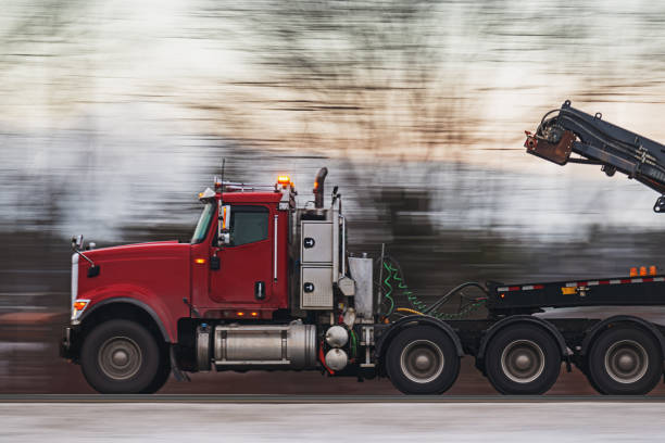Semi truck on a multi lane highway in Winter. Slow shutter panning shot with lots of motion blur.