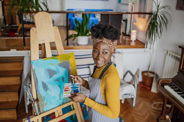istock A young female artist expresses her creativity through painting 1365002943