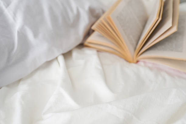 istock cozy bedroom with bed and book, copy space for your text 1365002999