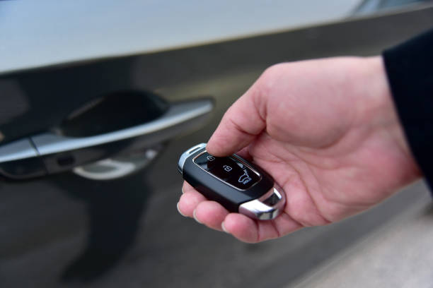 istock Female hand presses on the remote control car alarm system 1365003043