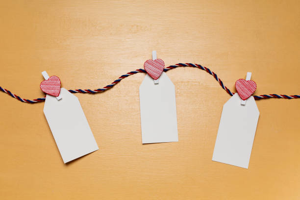 istock Minimalistic simple Valentine`s day concept, empty white cards for wishes with little red heart pins 1365003271