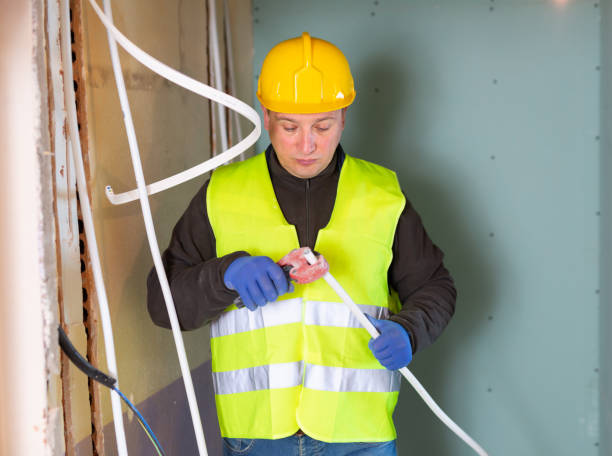 istock Repair man cutting cable duct for wires 1365004686