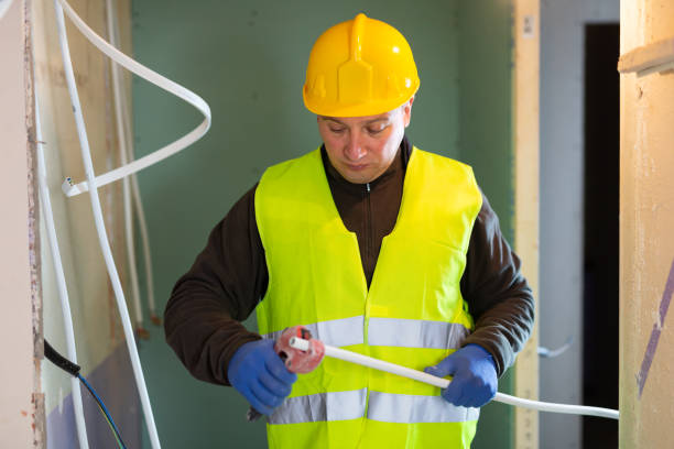 istock Repair man cutting cable duct for wires 1365004689