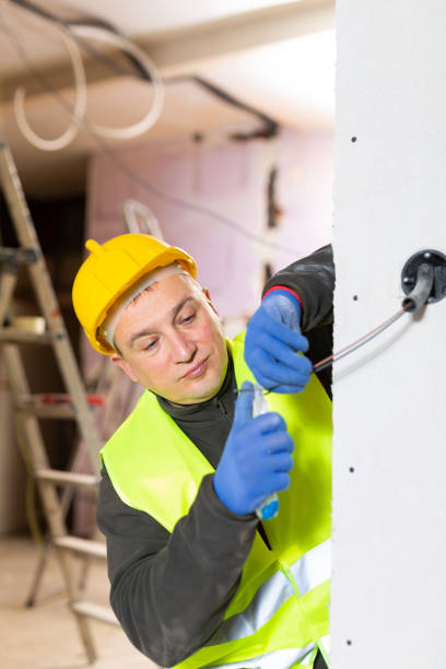istock Electrician mounting electrical wiring inside building in process of construction 1365004731